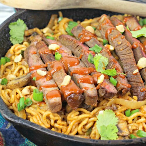 A pan of the korean spicy noodles with steak.