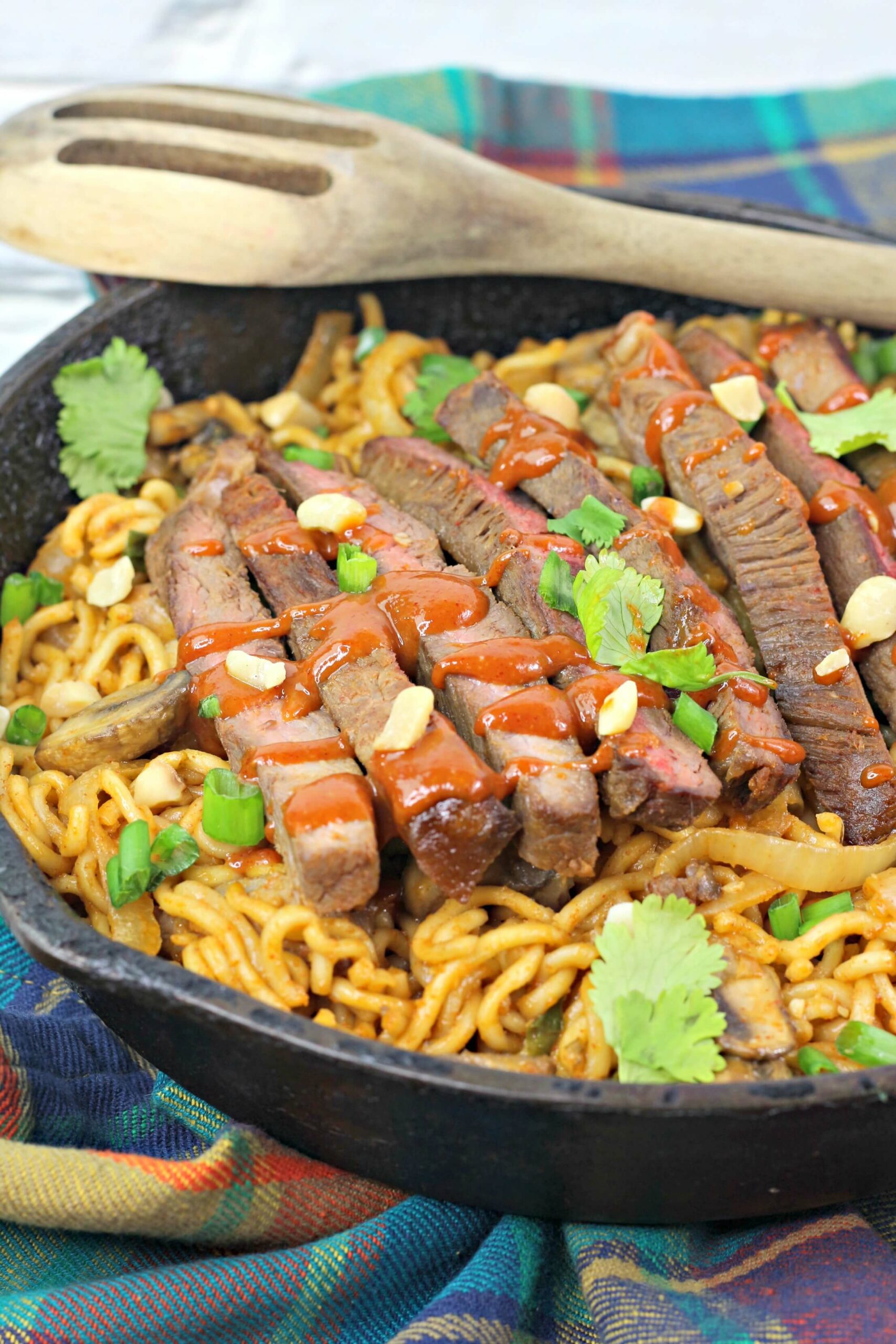 A pan of the korean spicy noodles with steak.