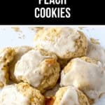 A close-up of several iced, chewy peach cookies arranged on a white surface with crumbs and dried peach slices nearby. A banner at the top proudly displays "Chewy Peach Cookies.