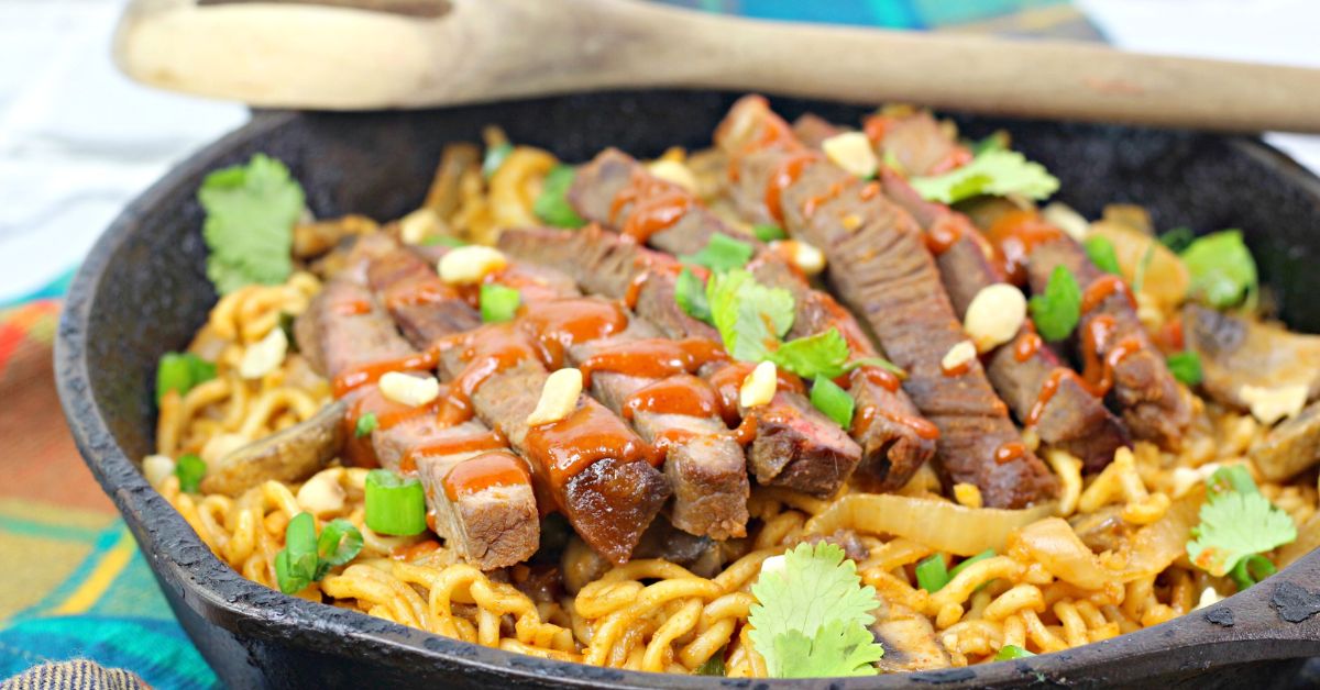 A close up of the pan of noodles and beef.