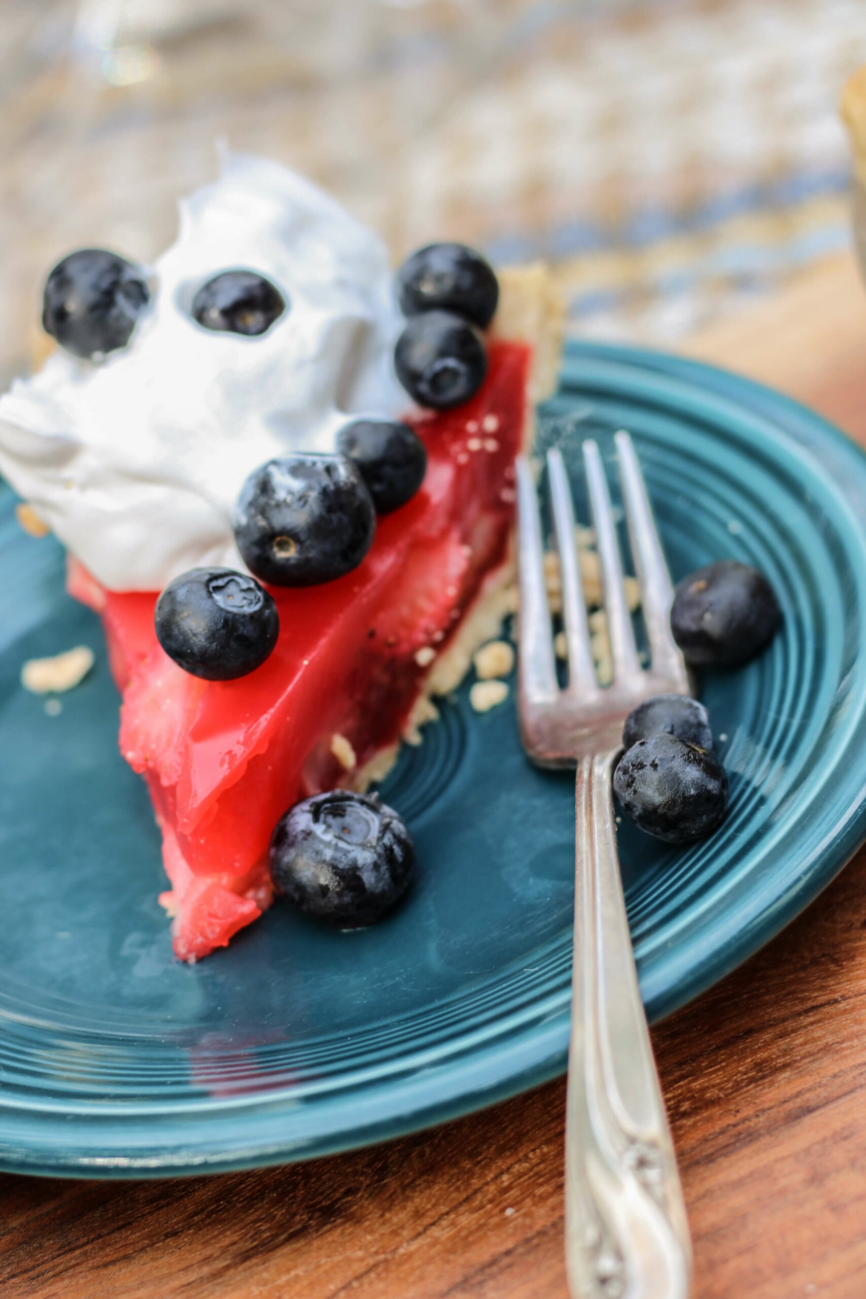 A strawberry jello pie topped with fresh fruit.