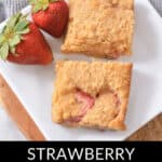 A plate with two delectable Strawberry Lemon Blondies and two whole strawberries on the side. Text at the bottom reads "Strawberry Lemon Blondies.