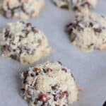 Scoops unbaked parchment-lined baking sheet.