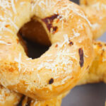 A close up view of the asiago cheese bagel with sundried tomatoes.