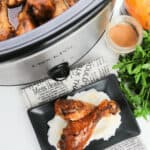 A slow Cooker with the chicken inside and a finished meal on the side.