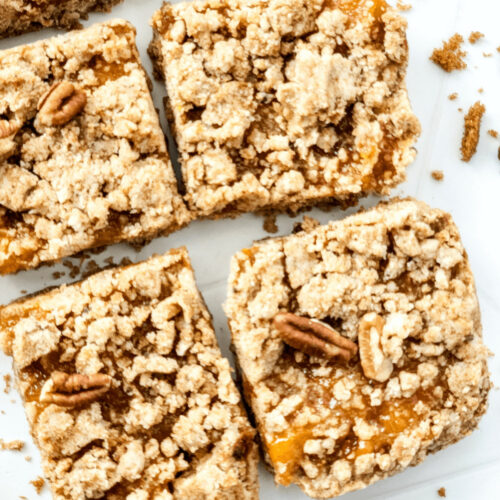 A tray of brown butter peach bars cut into squares.
