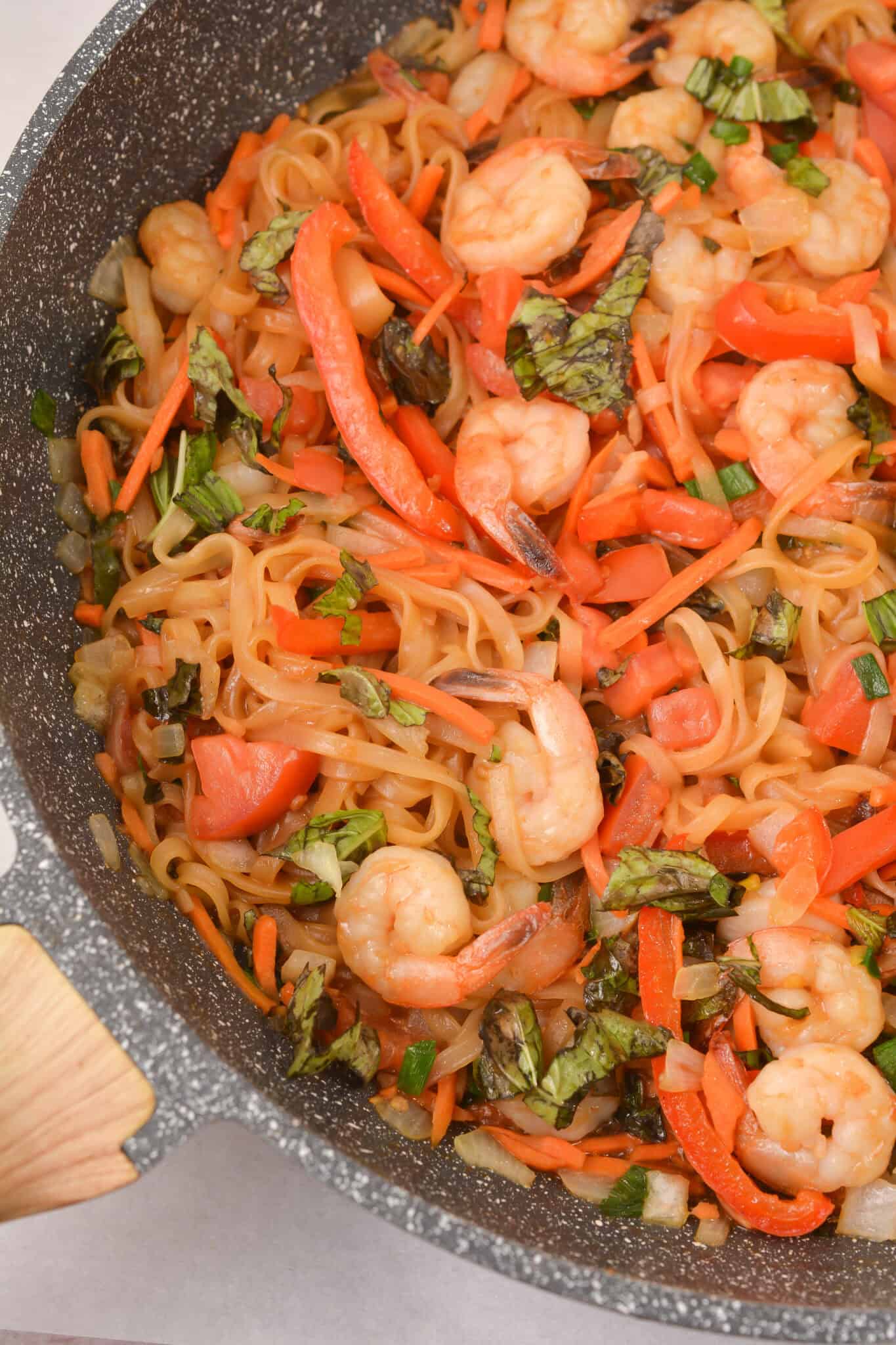 Shrimp drunken noodles in a pan.