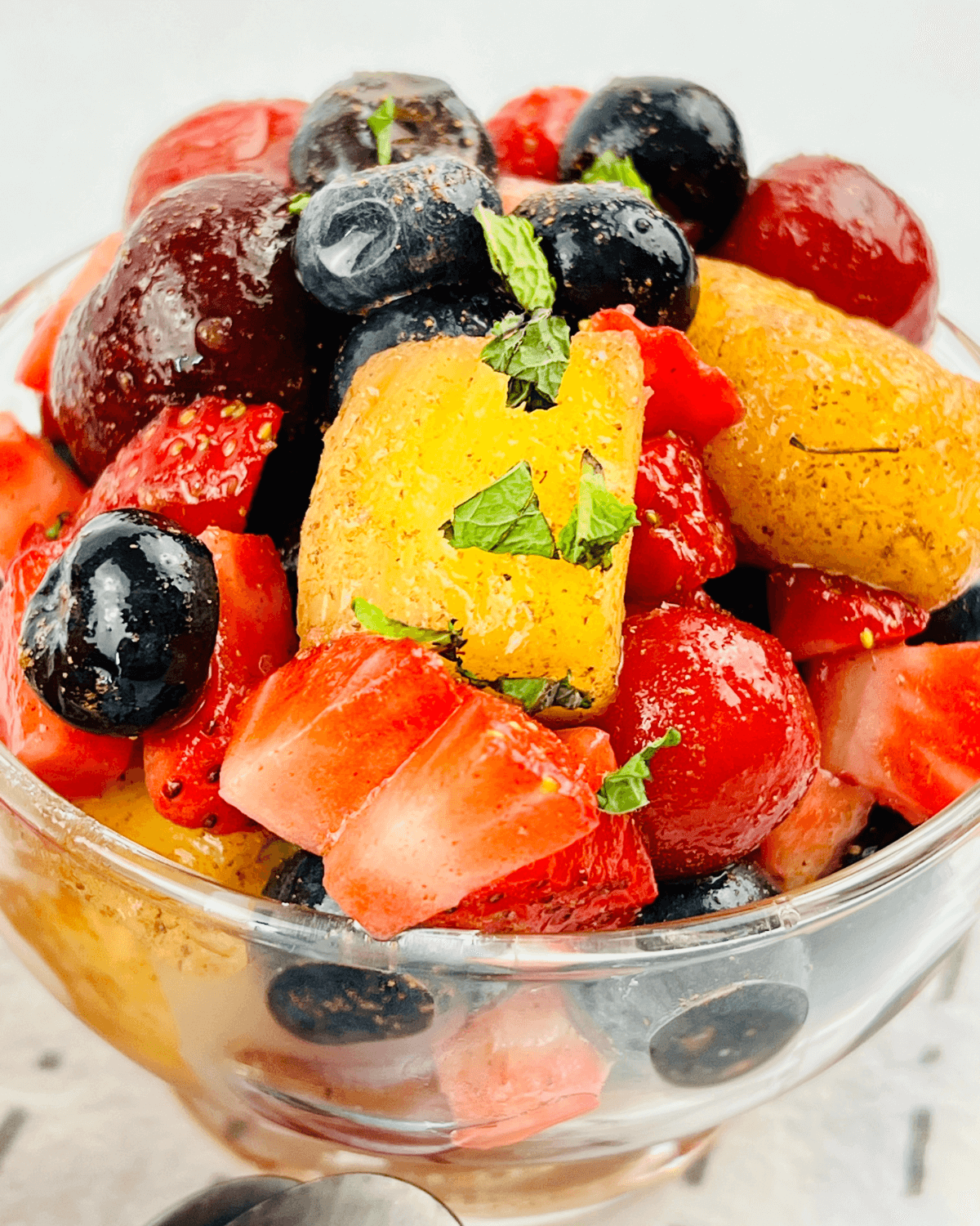 A fruit salad with honey lime dressing.