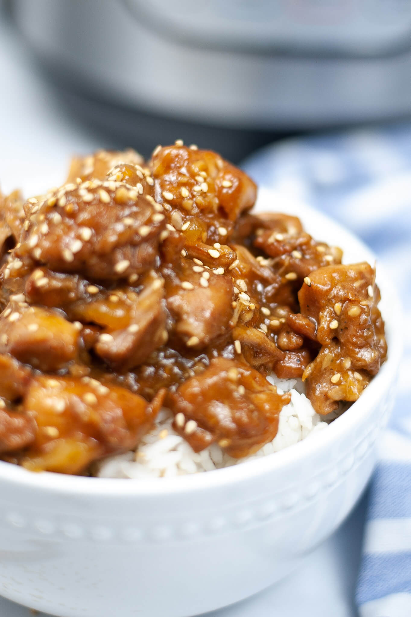 A close view of Instant pot chicken teriyaki in a white bowl.