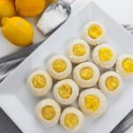 A white platter with the lemon cookies arranged on them.