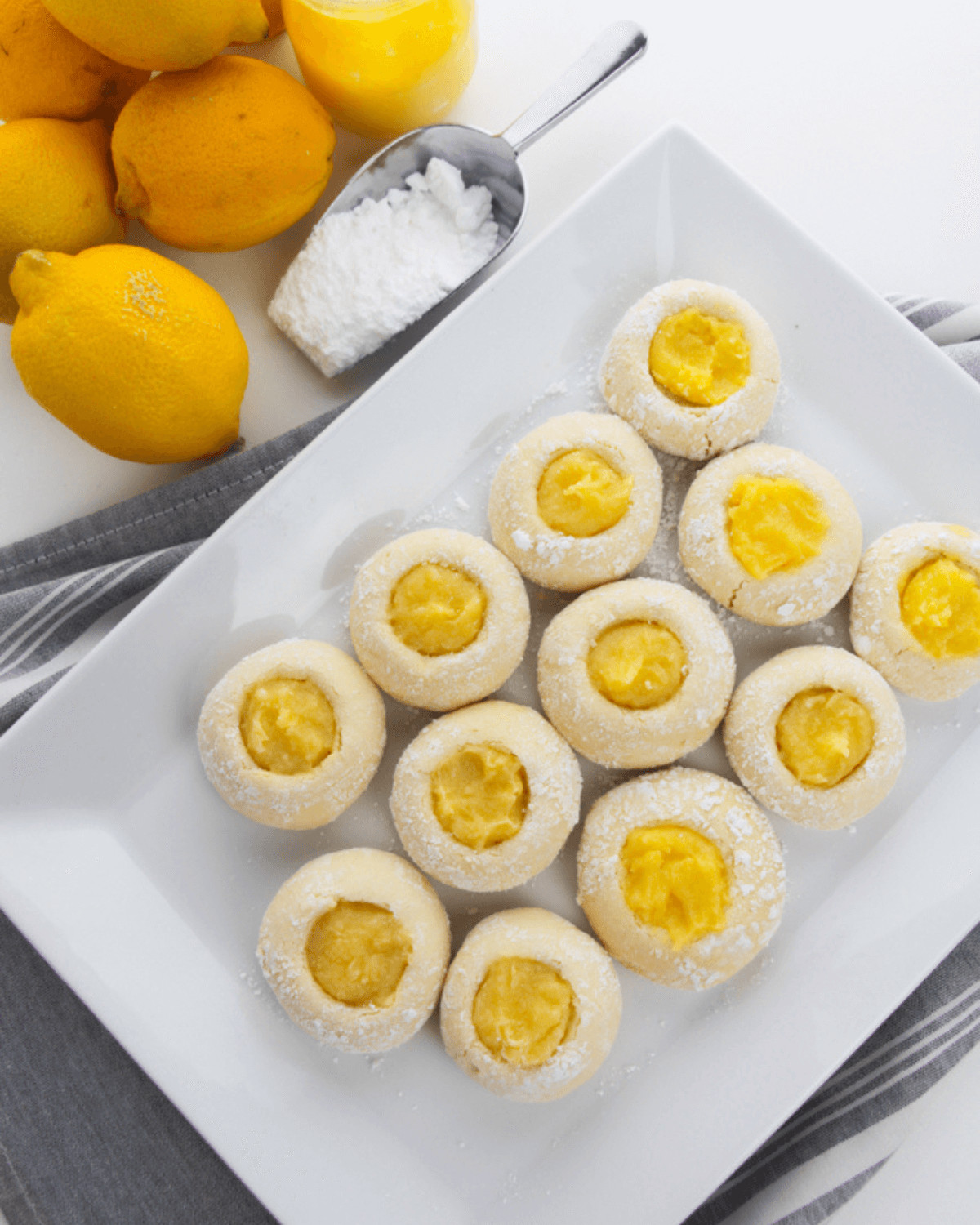 A white platter with the lemon cookies arranged on them.