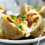 A close look at the instant pot loaded steam potatoes on a white plate.