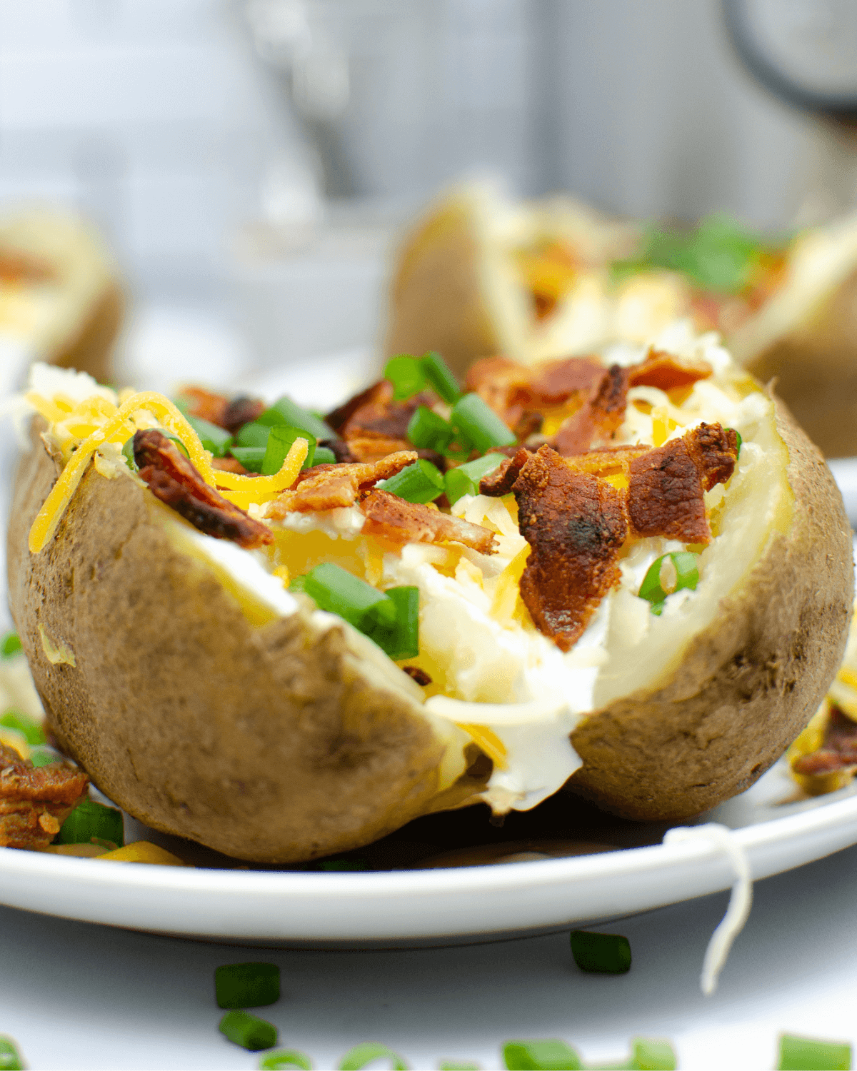 A close look at the instant pot loaded steam potatoes on a white plate.