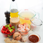 Red curry shrimp ingredients including spices, broth and sauce items.