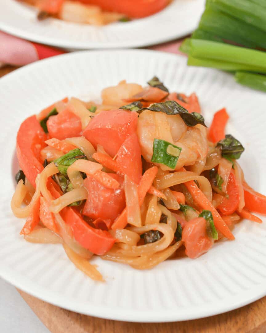Shrimp drunken noodles on white plate.