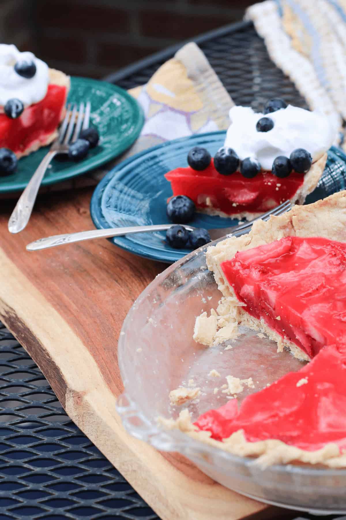 The strawberry jello pie with a slice taken out.