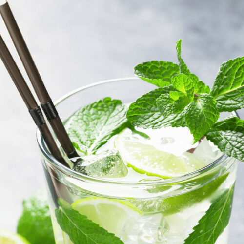 A glass with bacardi cuban mojito and fresh lime.