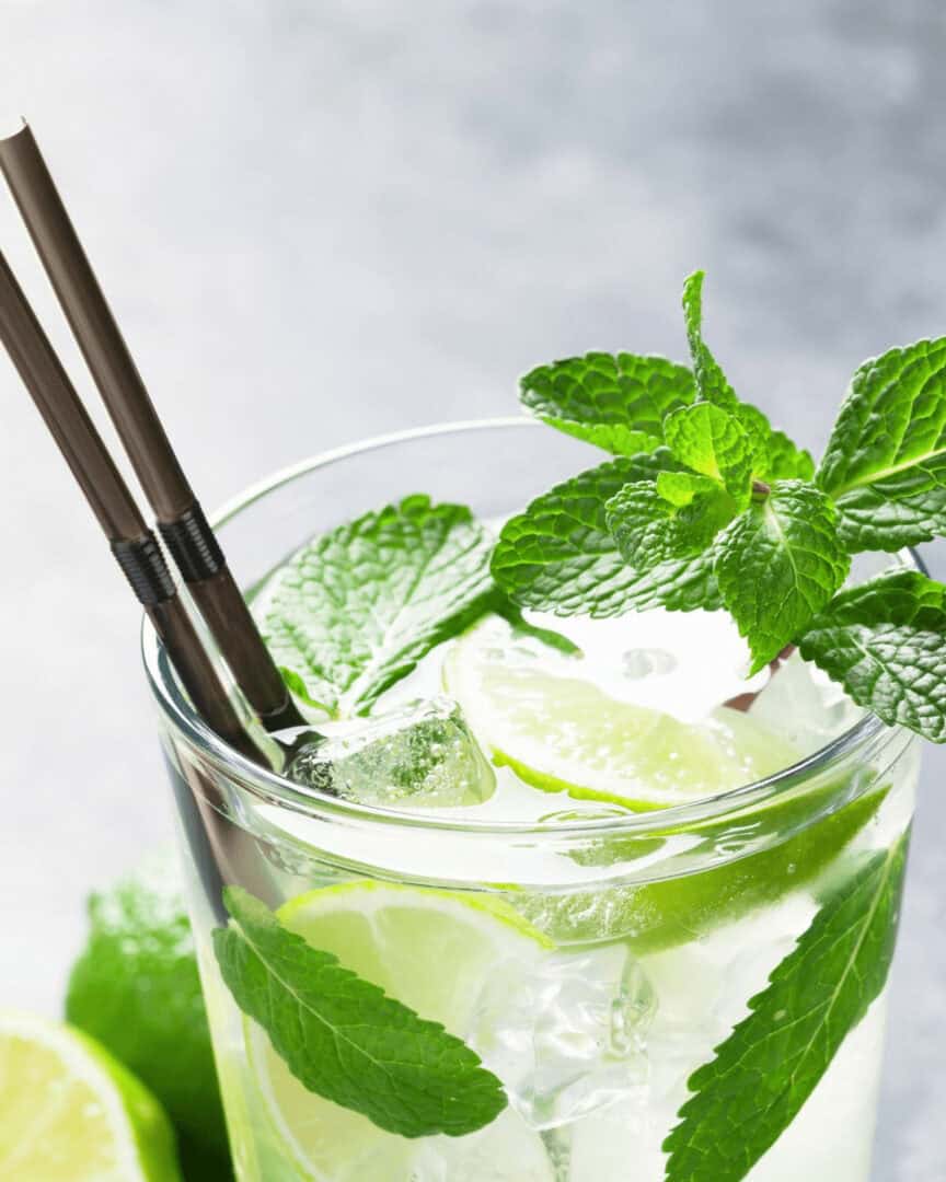 A glass with bacardi cuban mojito and fresh lime.
