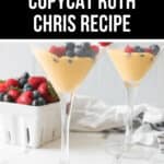 Two martini glasses filled with creamy yellow pudding topped with blueberries and raspberries. A white container filled with berries is in the background. Text reads, "Copycat Ruth Chris Recipe: Berries and Cream Delight.