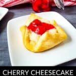 A cherry cheesecake bite with a golden crust and cherry topping sits on a white plate, showcasing the perfect treat from this Cheesecake Bites Recipe, with a jar of cherries and a red-striped cloth in the background.