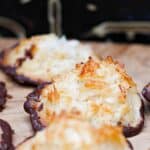 Cookies dipped in chocolate, arranged on a parchment-lined surface.