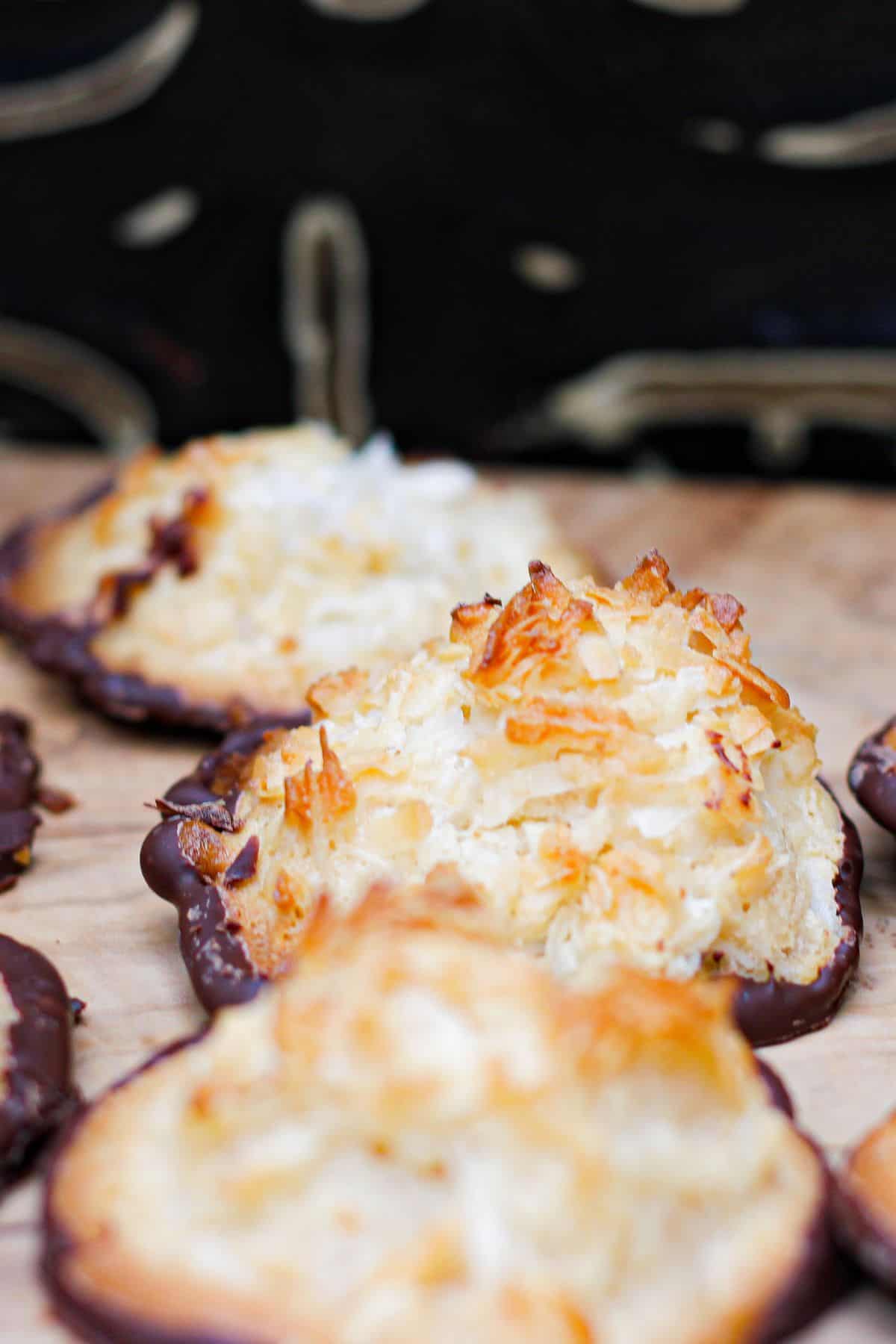 Cookies dipped in chocolate, arranged on a parchment-lined surface.