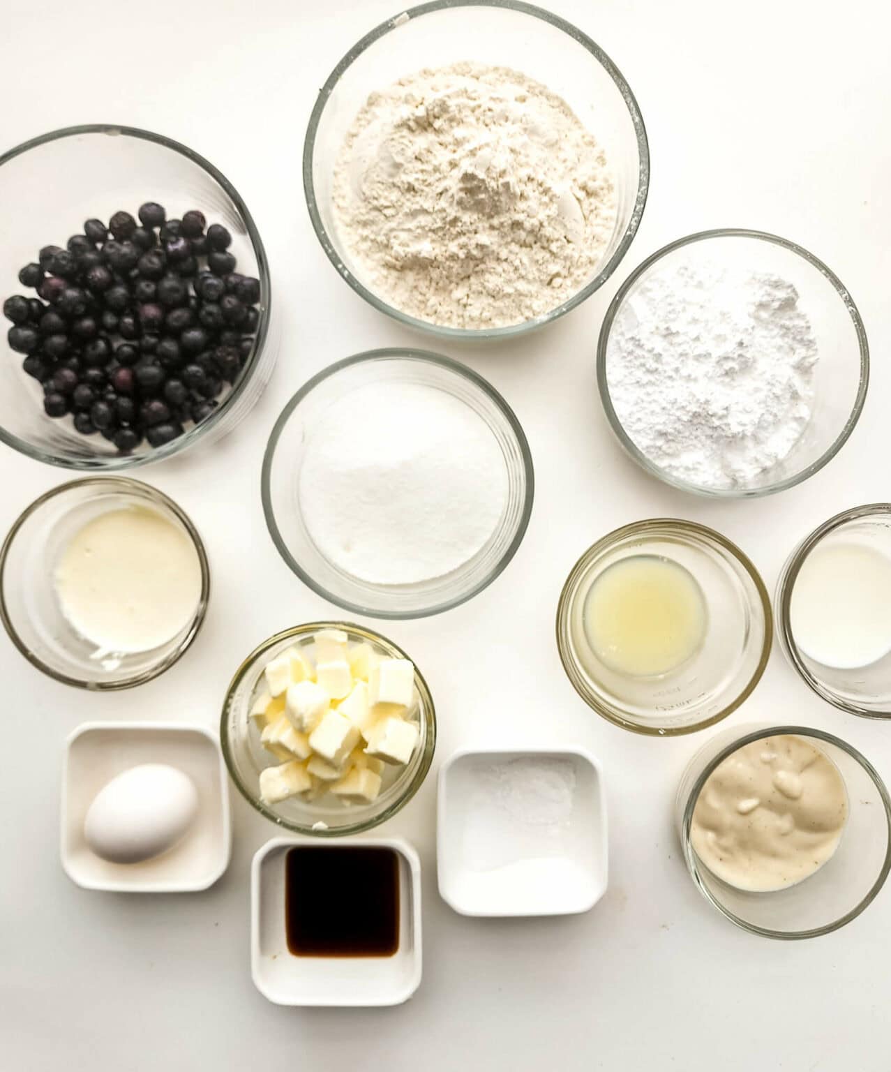 Butter, eggs. flour, sugar and blueberries.