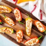 A wooden platter with the appetizer arranged on it.