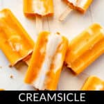 Orange and white creamsicle popsicles spread out on a white surface. Text at the bottom reads "Orange Popsicles: Creamsicle Delight.