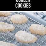 Lemon Cooler Cookies dusted with powdered sugar are cooling on a wire rack, filling the kitchen with a bright citrus aroma.