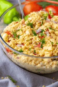 A clear bowl of lemon orzo pasta salad.