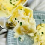 A bite of a fork of the cheesy dish.