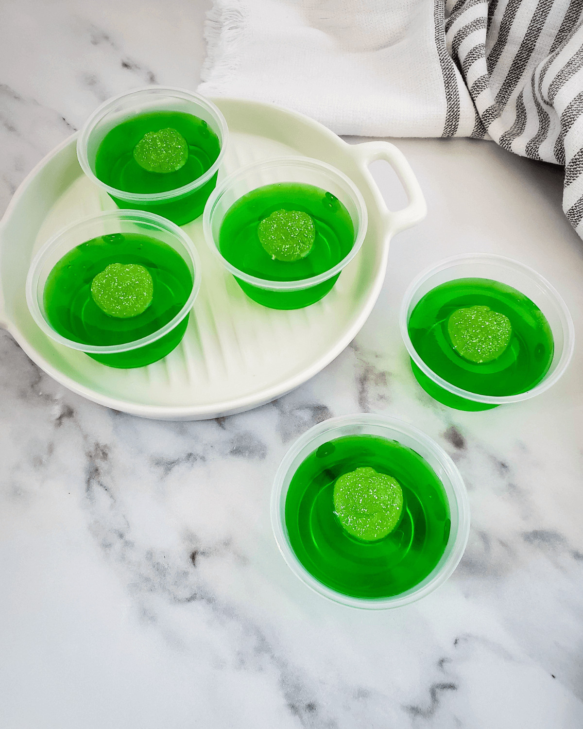 Green shots on a white tray.