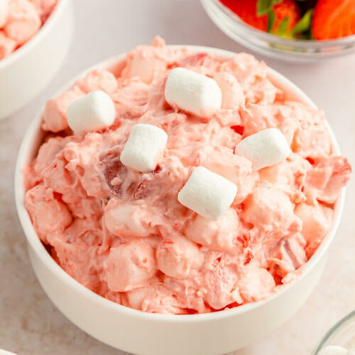 A white bowl of strawberry fluff salad.