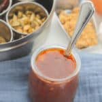 A top shot of a bbq with the Texas sauce in the picture.