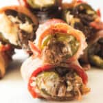 Appetizer filled with cream cheese and shredded meat, stacked invitingly on a pristine white surface.
