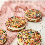 A tray of the sandwich cookies covered in colorful sprinkles.