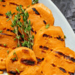 A platter of sweet potatoes on the grill.
