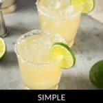Two glasses of Classic Margarita with salted rims, ice, and lime slices sit on a gray surface. Text at the bottom reads: "Simple Classic Margarita.