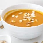 A white bowl filled with the warm lunch option with seeds on top.