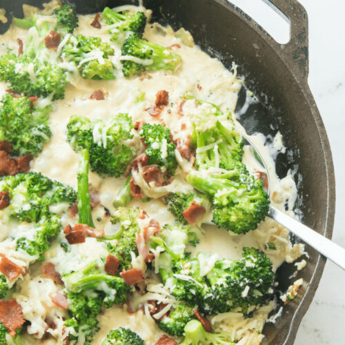 Creamy Broccoli in Parmesan Garlic Sauce in a cast iron pan.