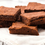 A white platter of amazing homemade brownies.