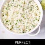 A white bowl filled with lime cilantro rice sits on a white surface, with a fresh lime and cilantro leaves in the background. The text below reads "Perfect Lime Cilantro Rice.