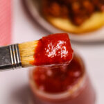 A brush covered in the thick sauce.