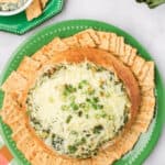 Spinach and Artichoke Dip on a plate with crackers, made without Mayo.