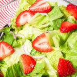 The assembled salad with the strawberries and the greens.