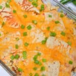 A glass baking dish with the dinner with melted cheese on top.