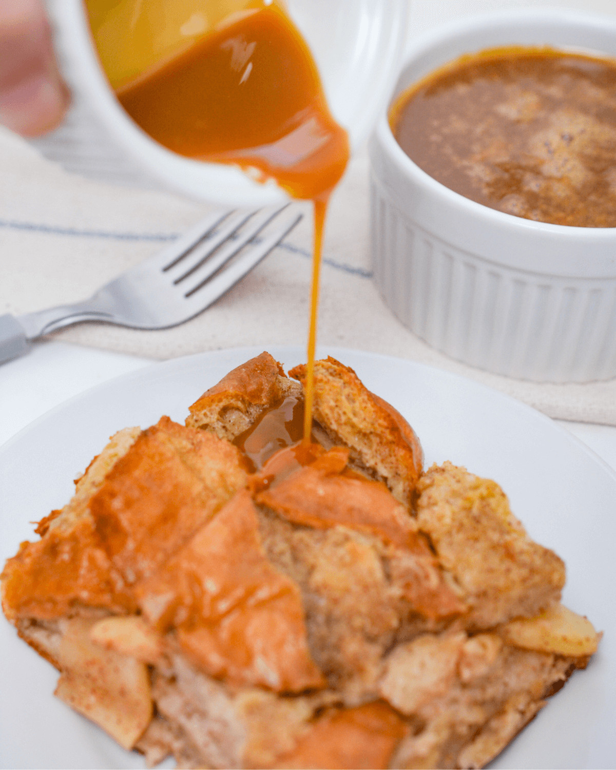 A drizzle of bourbon caramel sauce over the bread pudding.