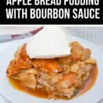 A slice of Bread Pudding with Bourbon Sauce, studded with apples and topped with vanilla ice cream, sits on a white plate as rich bourbon sauce pools around it.