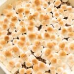 Casserole dish filled with Candied Sweet Potatoes with Canned Sweet Potatoes, topped with browned mini marshmallows.